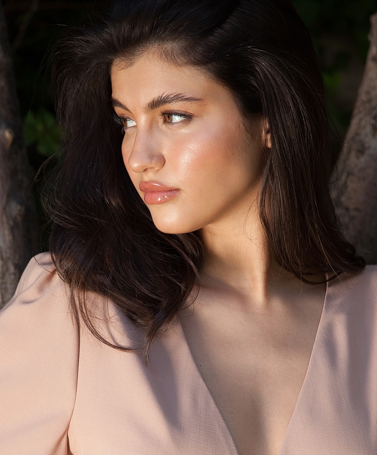 Young woman with long hair in soft lighting.
